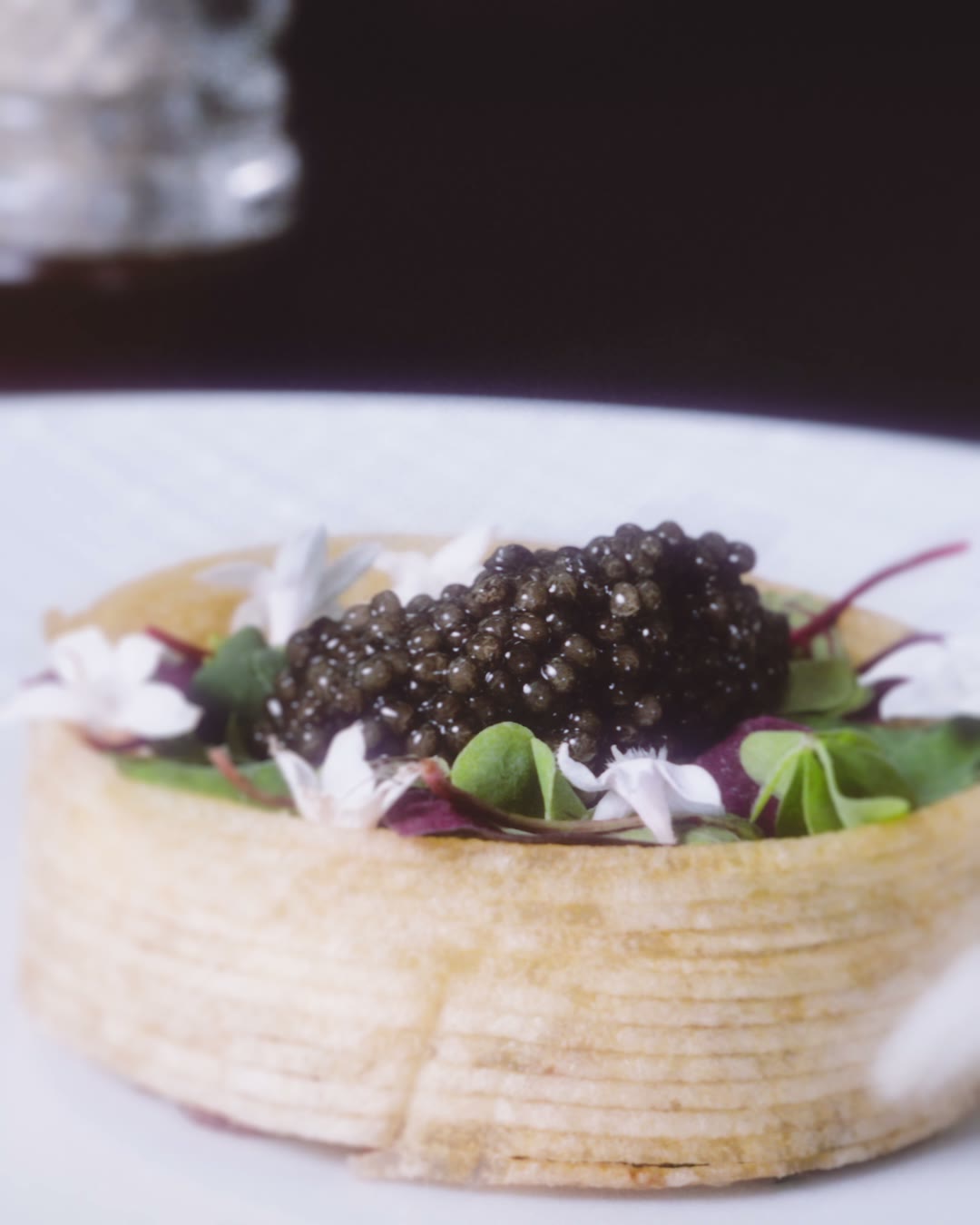 A plate from the four-hands dinner topped with Prunier oscietra caviar and flowers