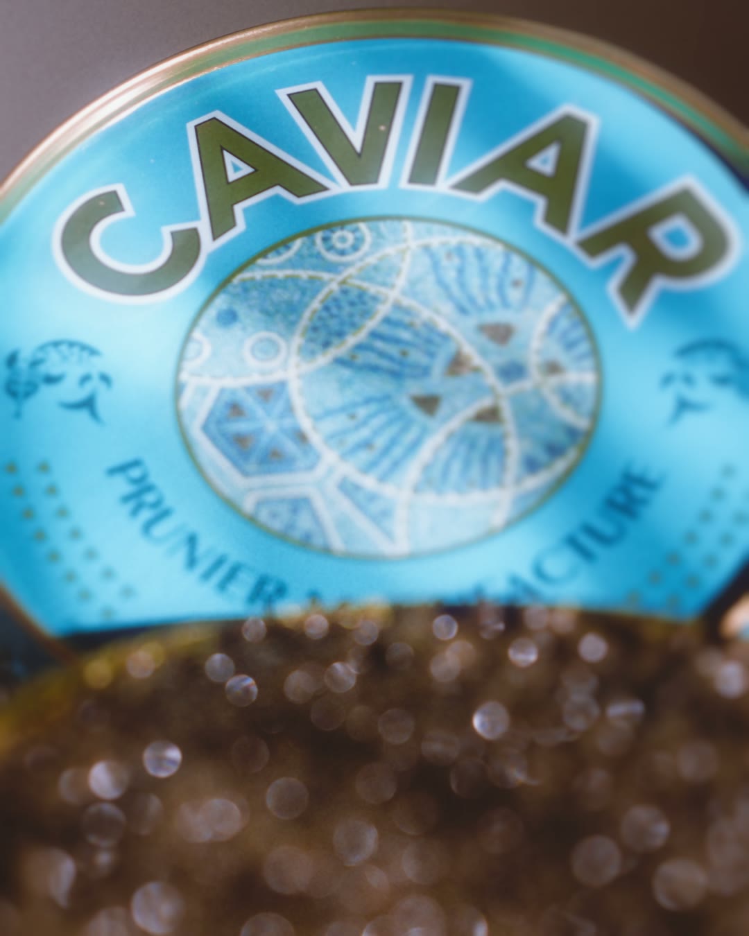Close-up of the blue Prunier caviar tin opening